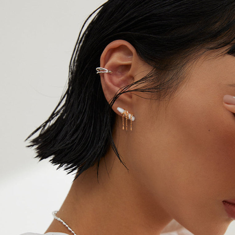 Solara 925 sterling silver earring on neutral background