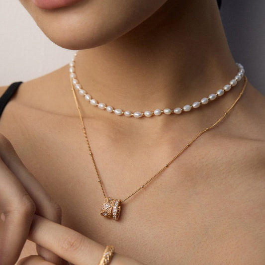 Solara natural pearl choker necklace with S925 silver, freshwater rice pearls, and shell beads on neutral background